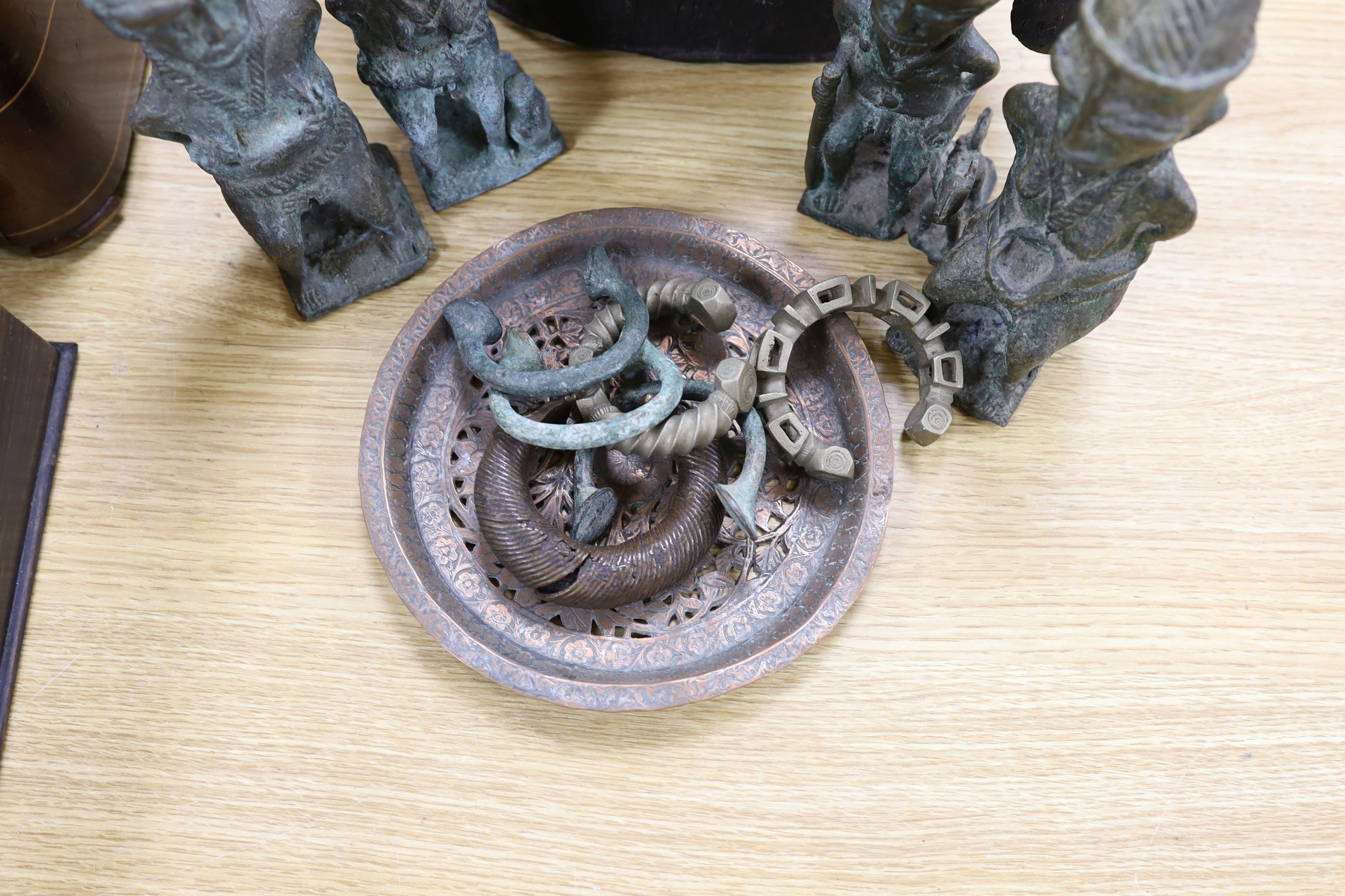 A group of Nigerian cast metal figures, bangles and a dish, tallest 36 cms high.